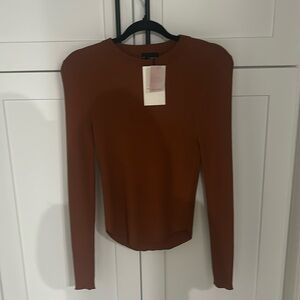 nice shirt with tags bought from a boutique brand is Miou Muse size medium